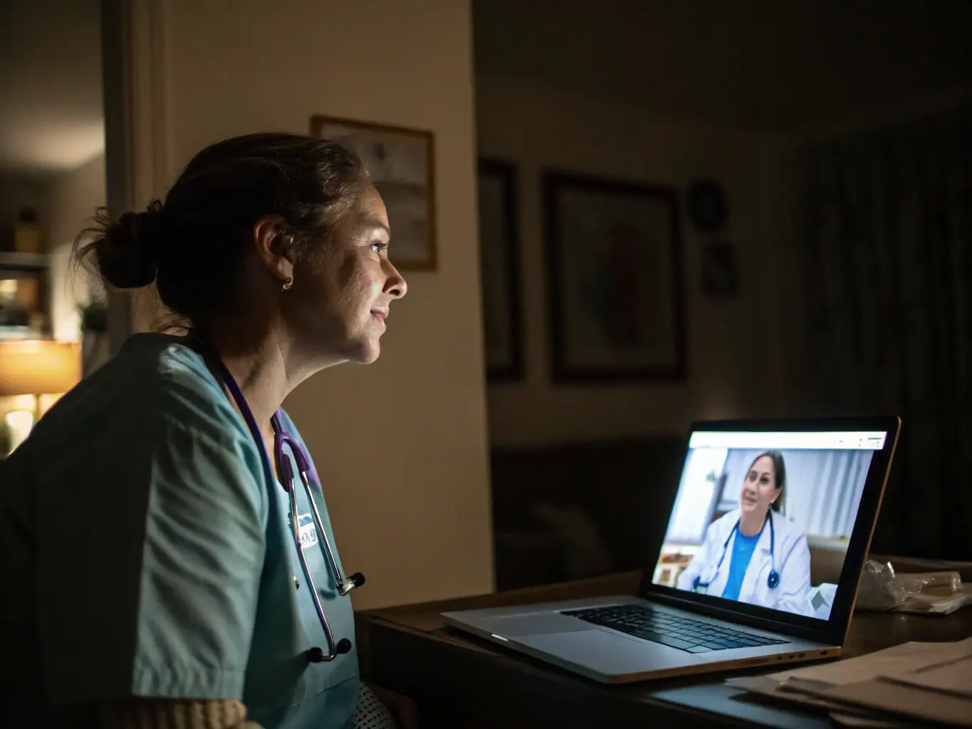 A healthcare professional demonstrating a telehealth platform on a laptop to a patient, representing Digital Health Solutions Advisory.